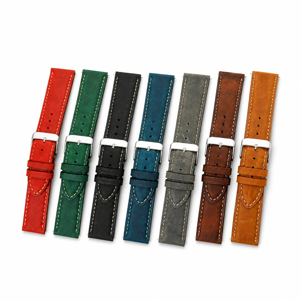 Seven Crazy Horse leather watch straps arranged together in red, green, black, blue, gray, brown, and tan on white