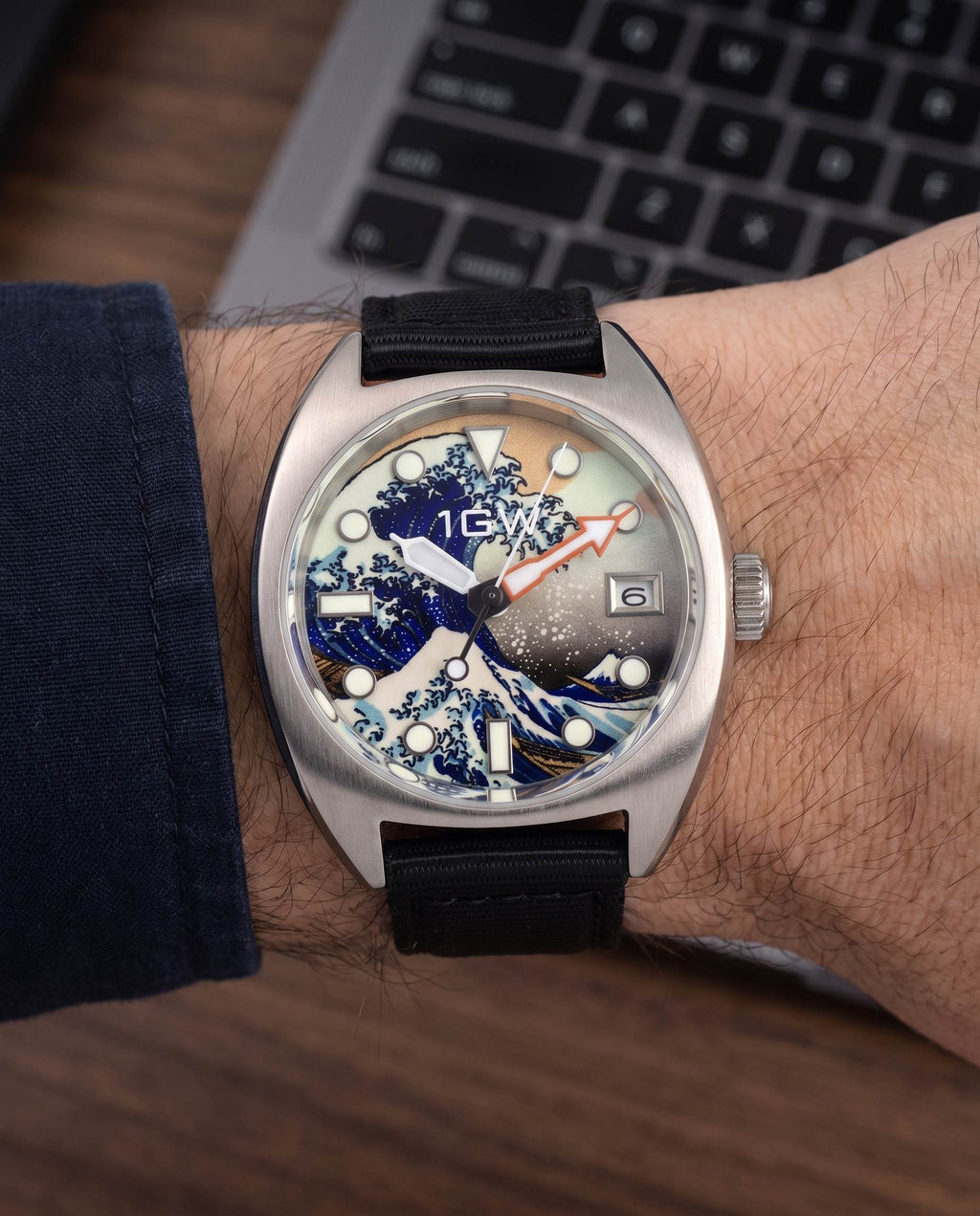 1GW Great Wave 36mm worn on the wrist beside a keyboard