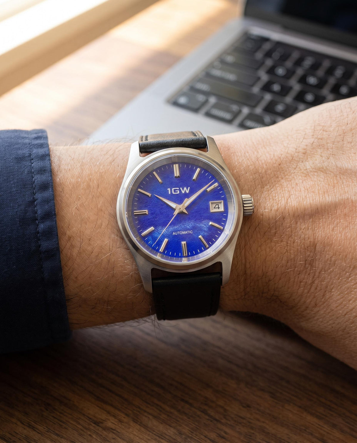 1GW Purple Frost 36mm automatic watch worn on the wrist beside a keyboard