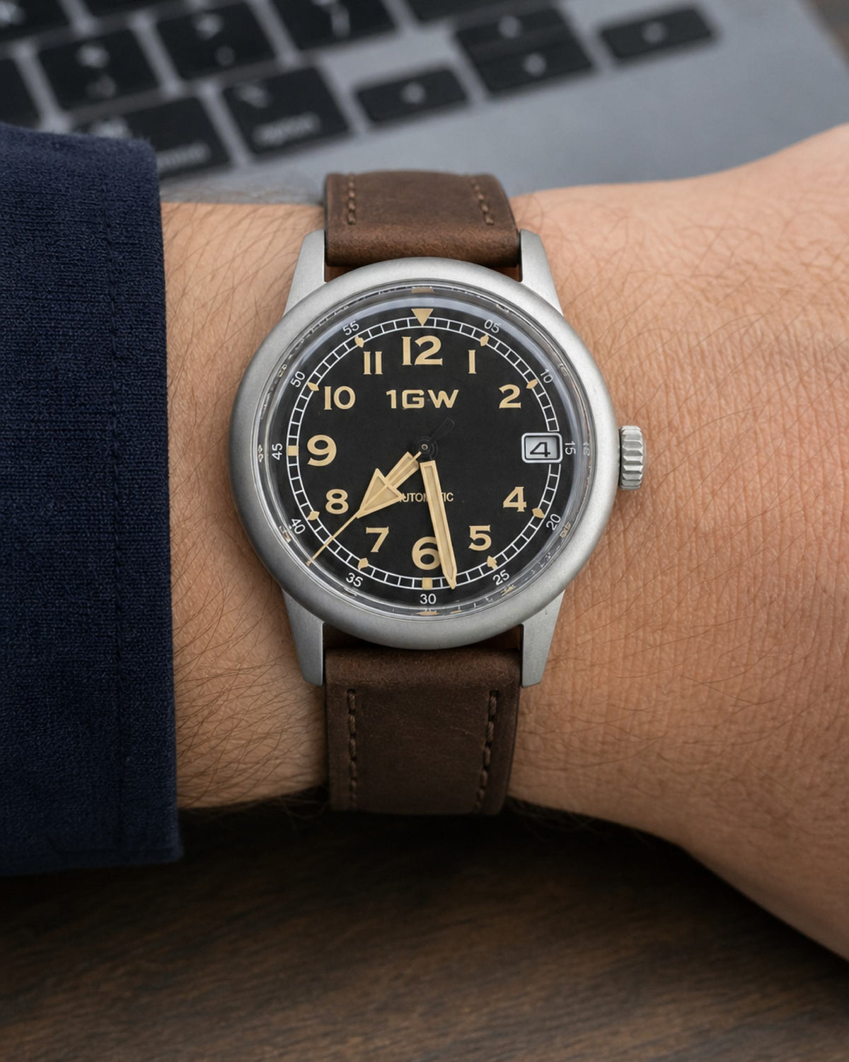1GW Vintage Flieger automatic watch with black dial and brown leather strap worn at a desk