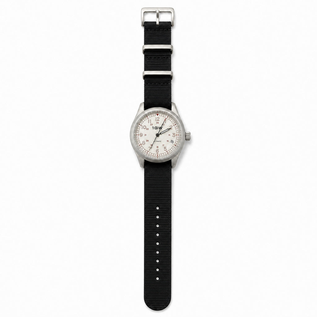 1GW White Field 24H automatic watch flat lay with standard-length black nylon NATO strap
