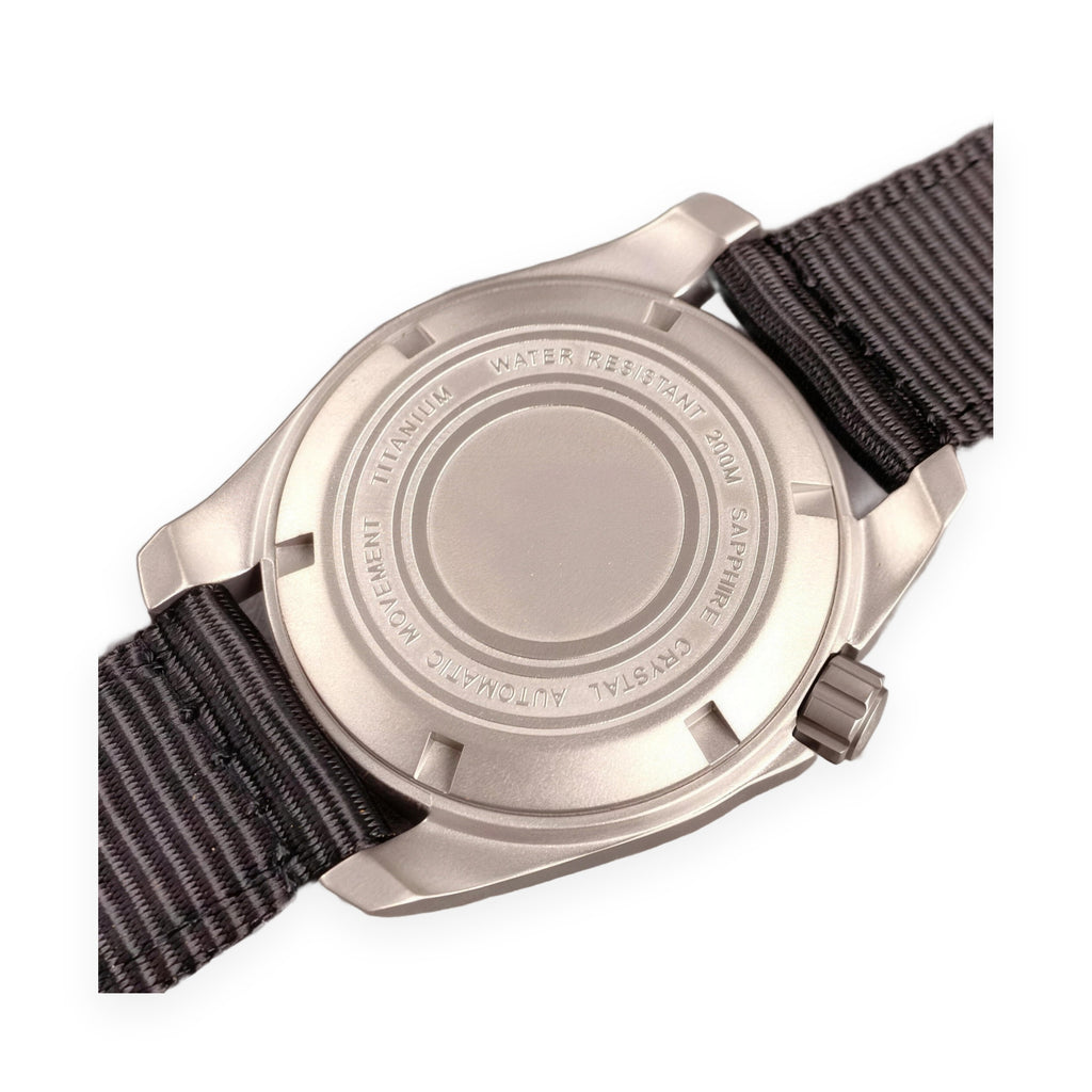 1GW Burgundy Field Day-Date Titanium 40mm caseback on white, engraved TITANIUM WATER RESISTANT 200M SAPPHIRE CRYSTAL AUTOMATIC MOVEMENT, black nylon strap