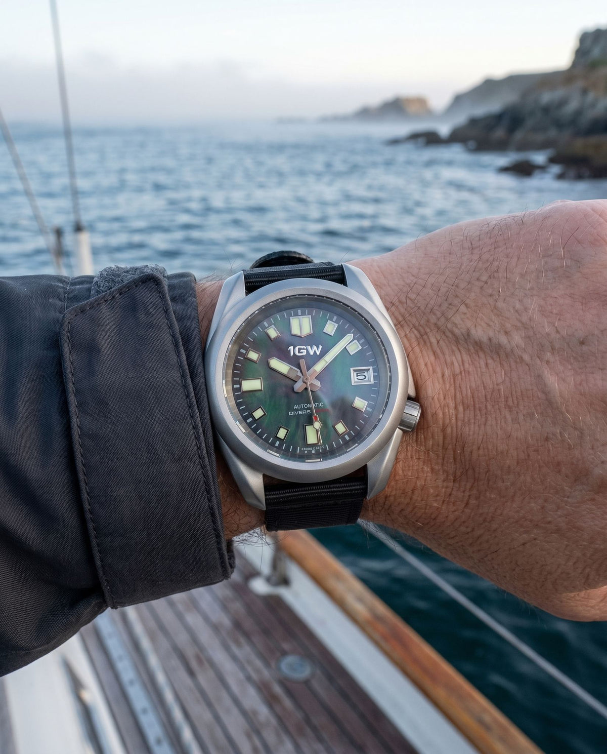 1GW Abalone Diver 200m Automatic worn on the wrist by the coast at sunrise