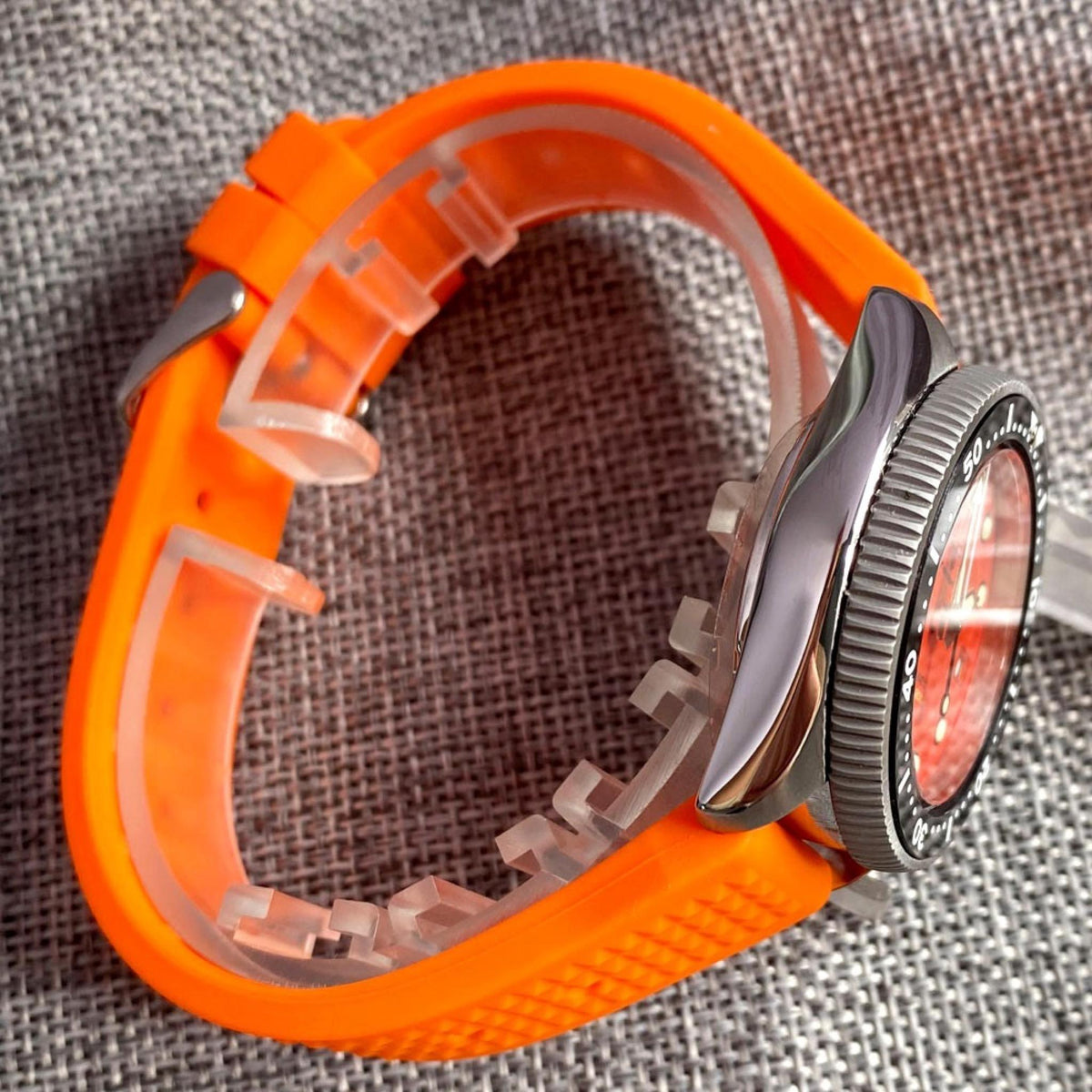 Orange Diver 37mm stainless-steel case side profile with orange rubber strap
