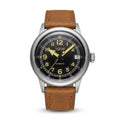 1GW Vintage Flieger automatic watch with black dial, gold-tone Arabic numerals, and brown leather strap on white