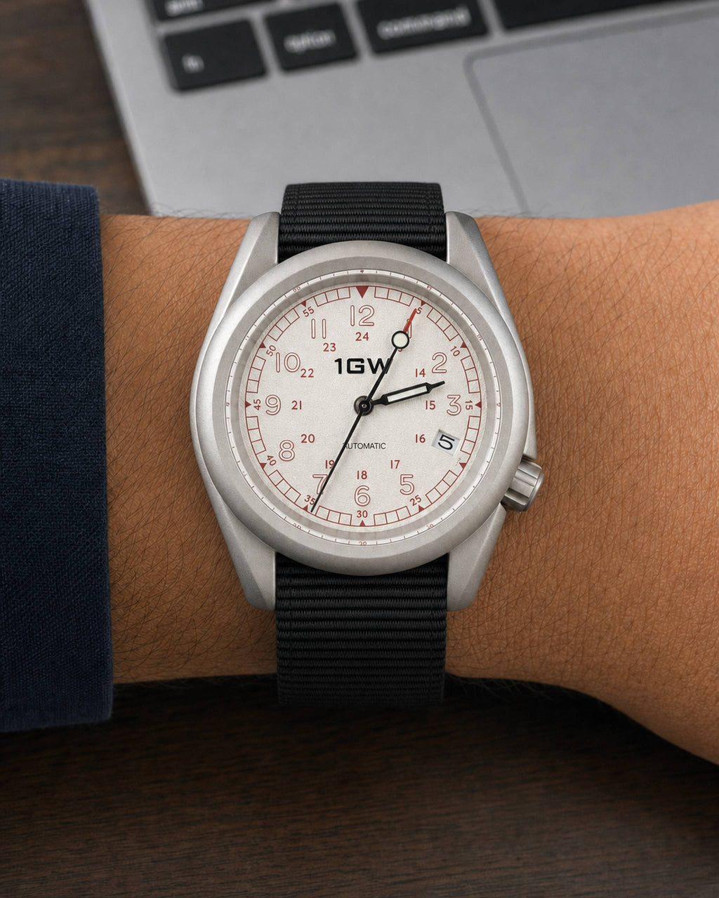 1GW White Field 24H on wrist beside a keyboard