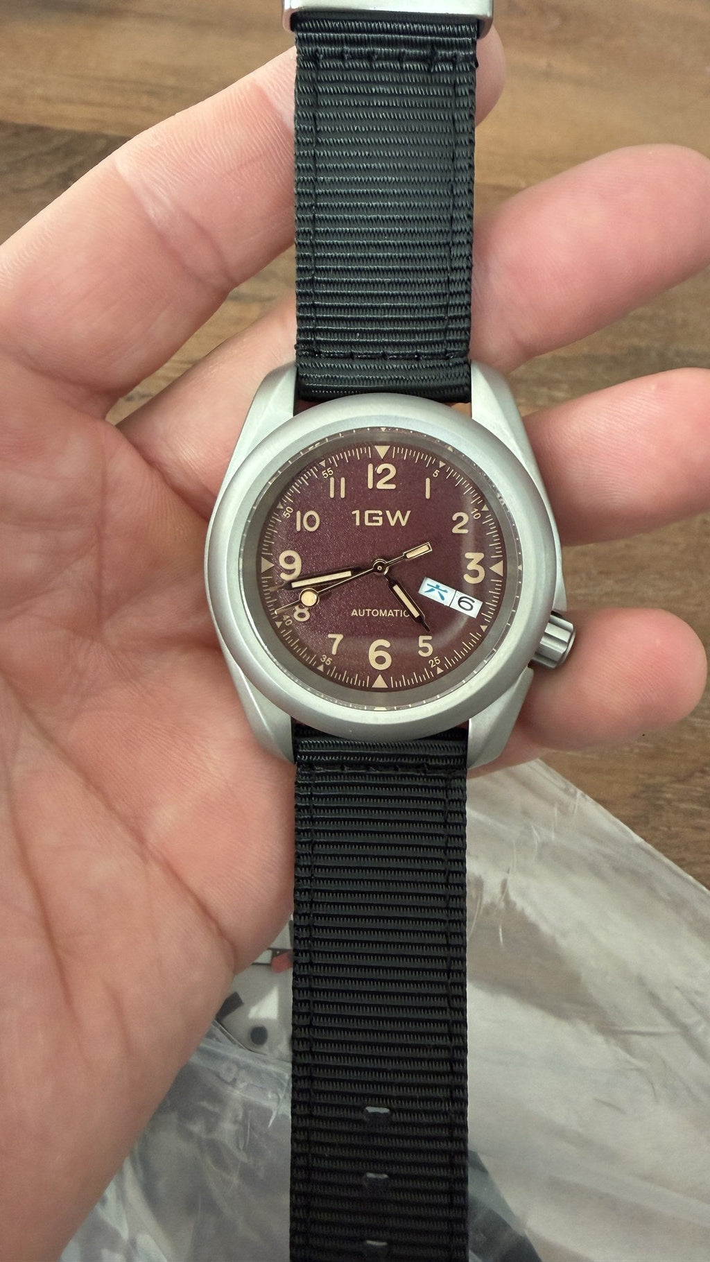1GW Burgundy Field Day-Date - actual unit in hand, burgundy dial with cream numerals