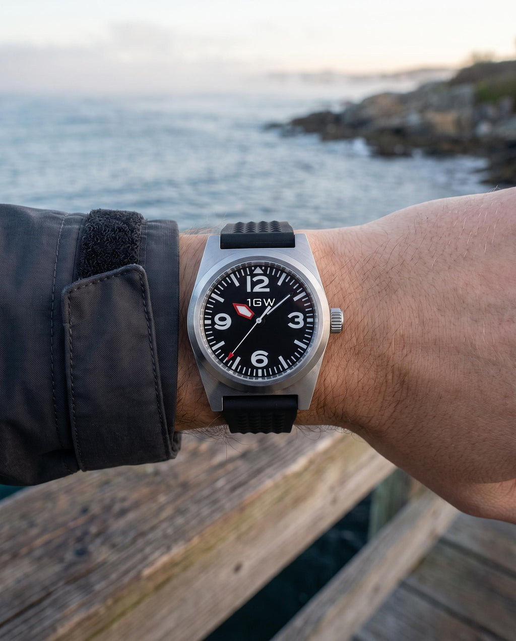 1GW Black Explorer PT5000 38mm worn on the wrist at the coast, black waffle rubber strap