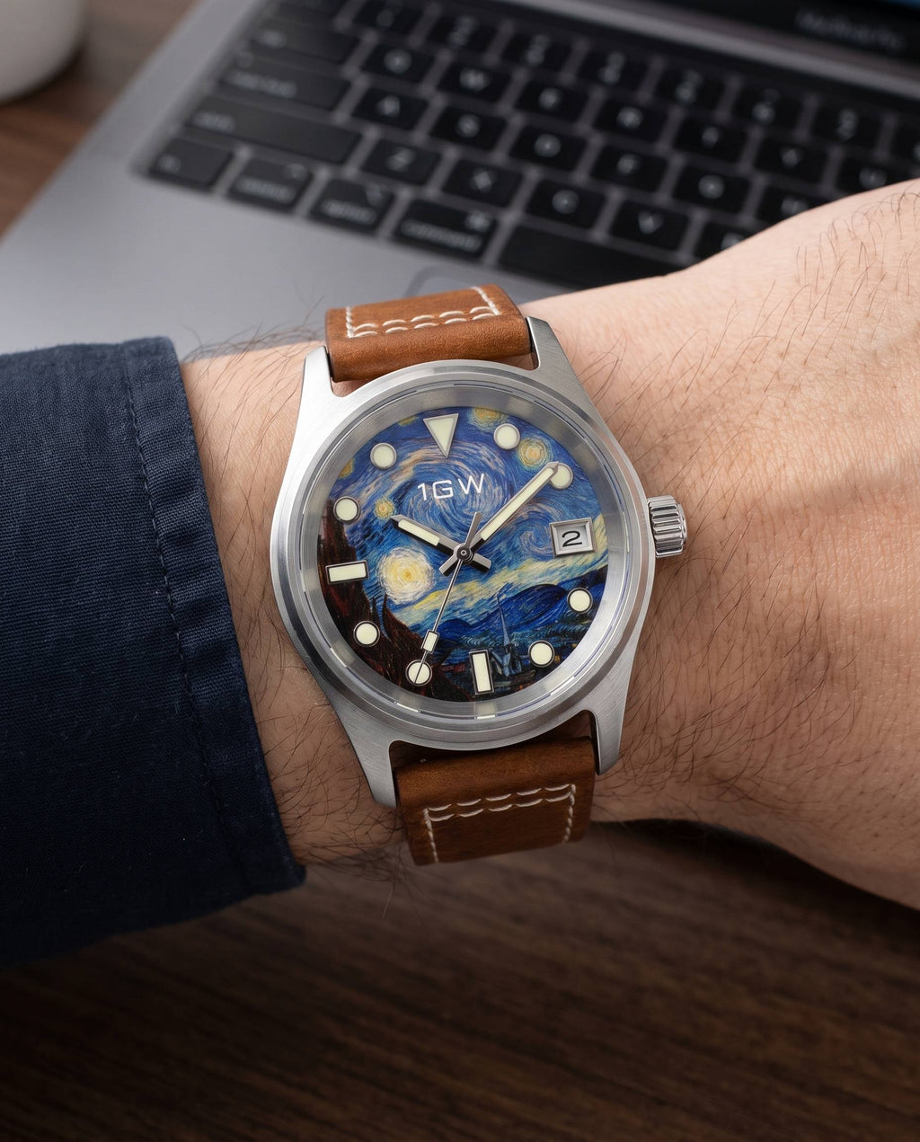 1GW Starry Night 36mm worn on the wrist beside a keyboard, brown leather strap with white stitch