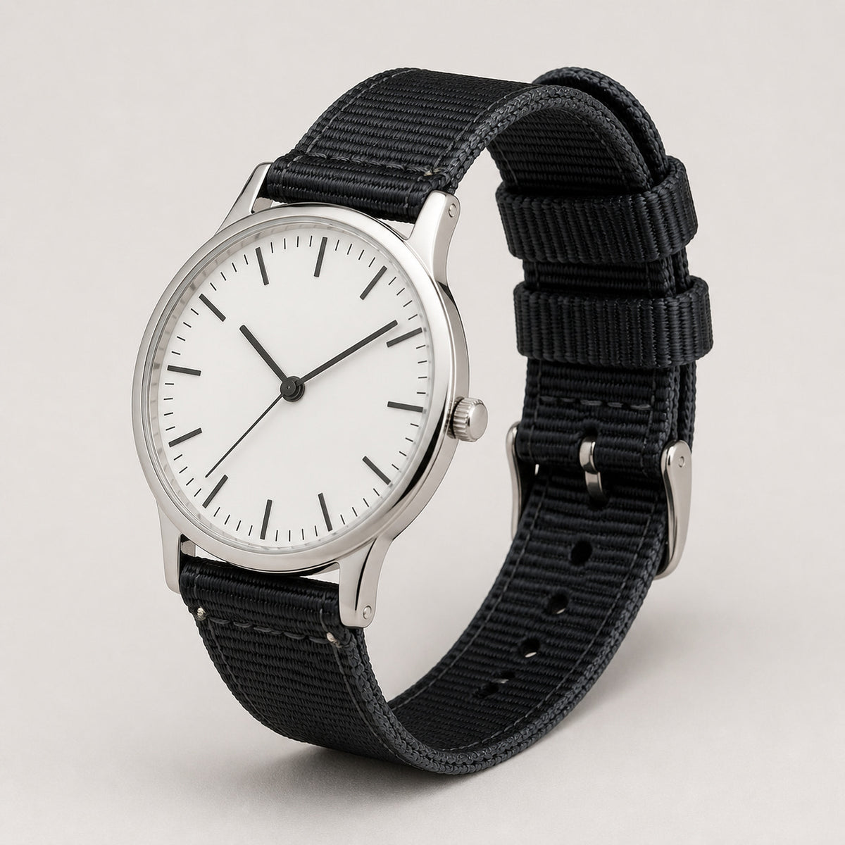 Black woven nylon quick-release strap installed on a slim silver watch