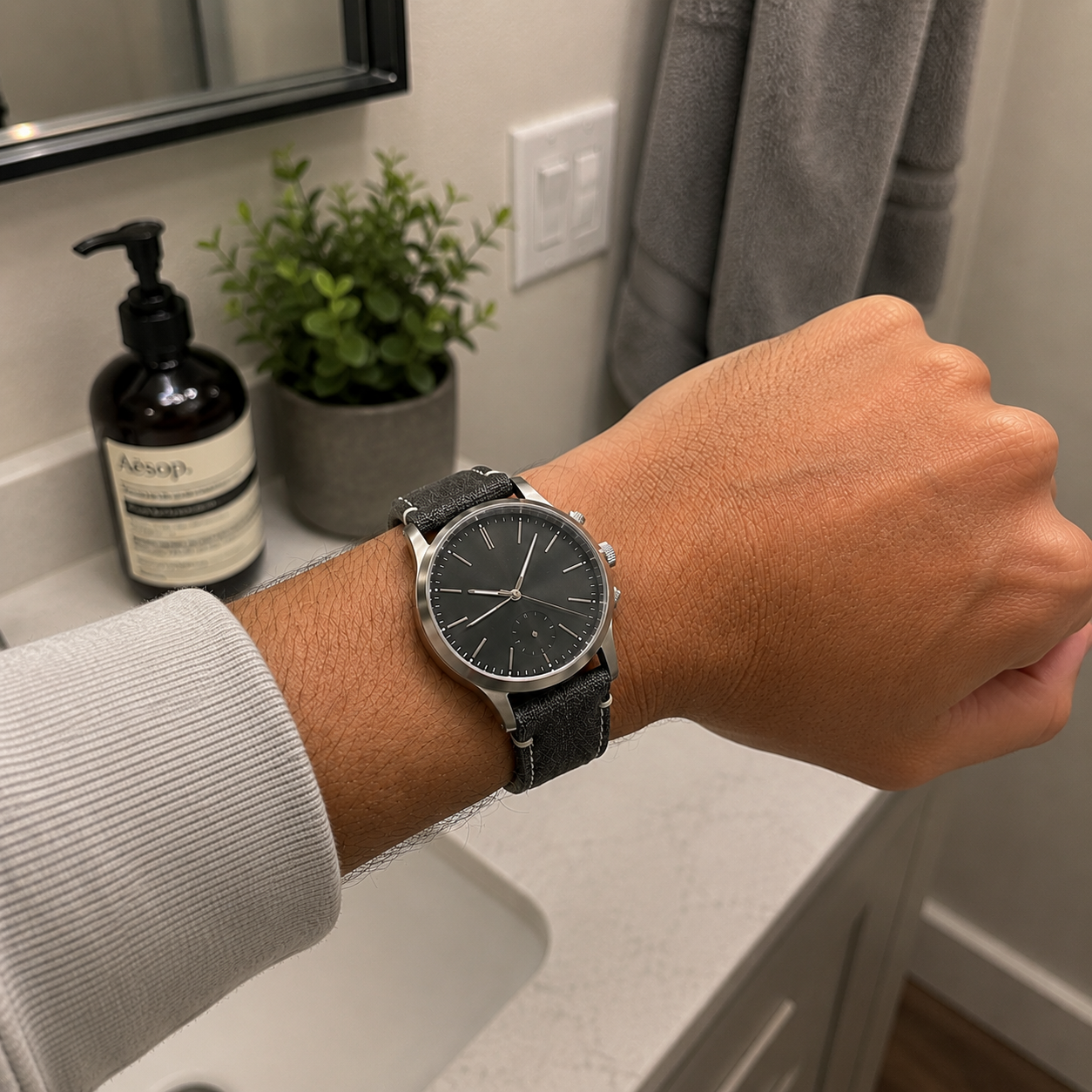 Customer-style iPhone bathroom wrist photo with black canvas strap