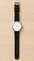 1GW Silicone + Nylon Hybrid Quick-Release Watch Strap 22mm in black, vertical top-down hero on light wood, high resolution