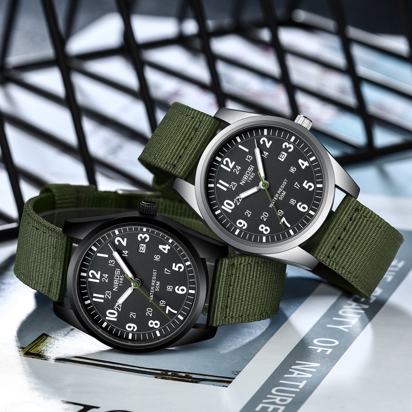 Two NIBOSI 2639 field watches, black dial and cream dial, side by side