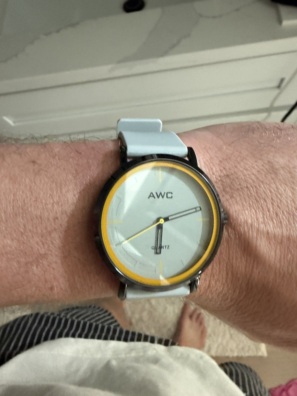 AWC Minimalist Quartz watch, grey dial with yellow ring, white silicone strap on wrist