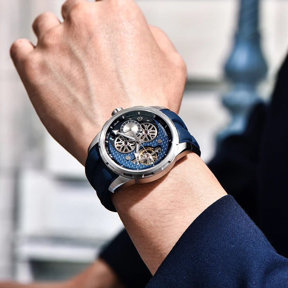 PAGANI DESIGN PD-YS022 Blue skeleton automatic watch with navy rubber strap worn on wrist