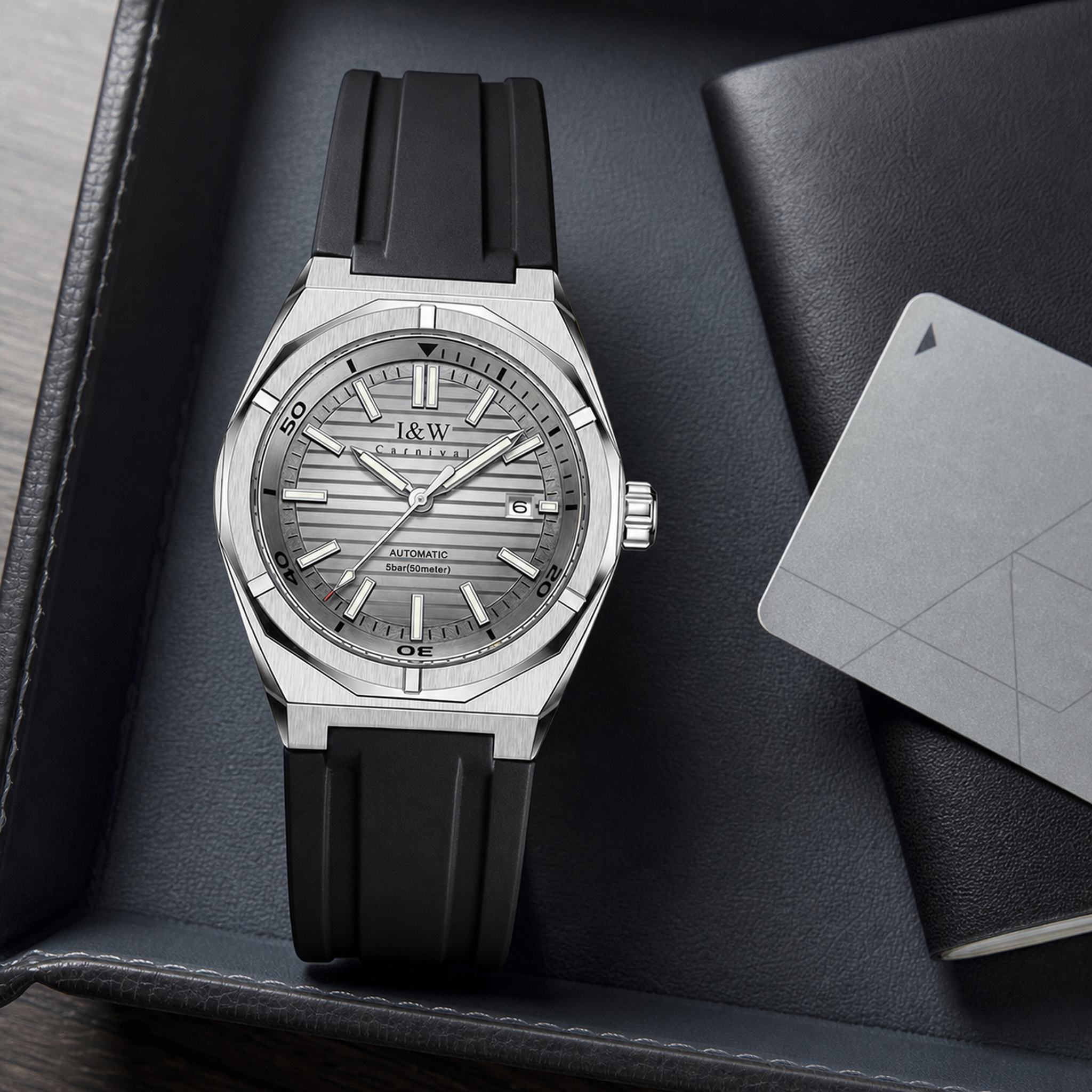 Carnival IW711G gray automatic watch on a black travel valet tray