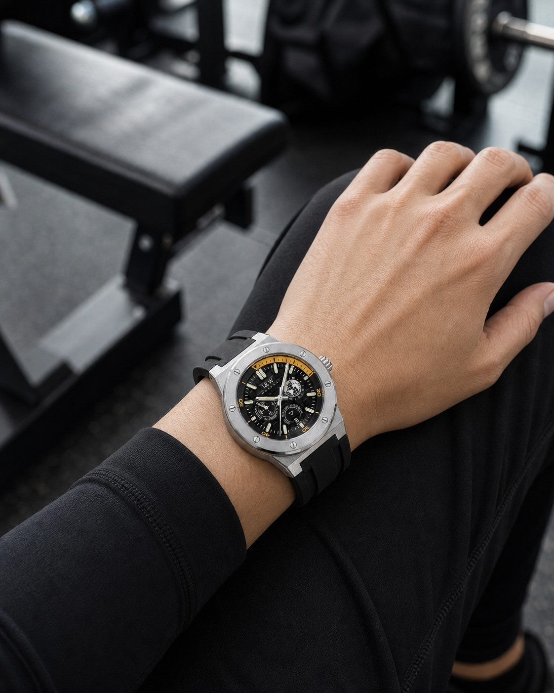 I&W Carnival IW783G black and gold automatic watch worn correctly on the outside of the wrist at a gym
