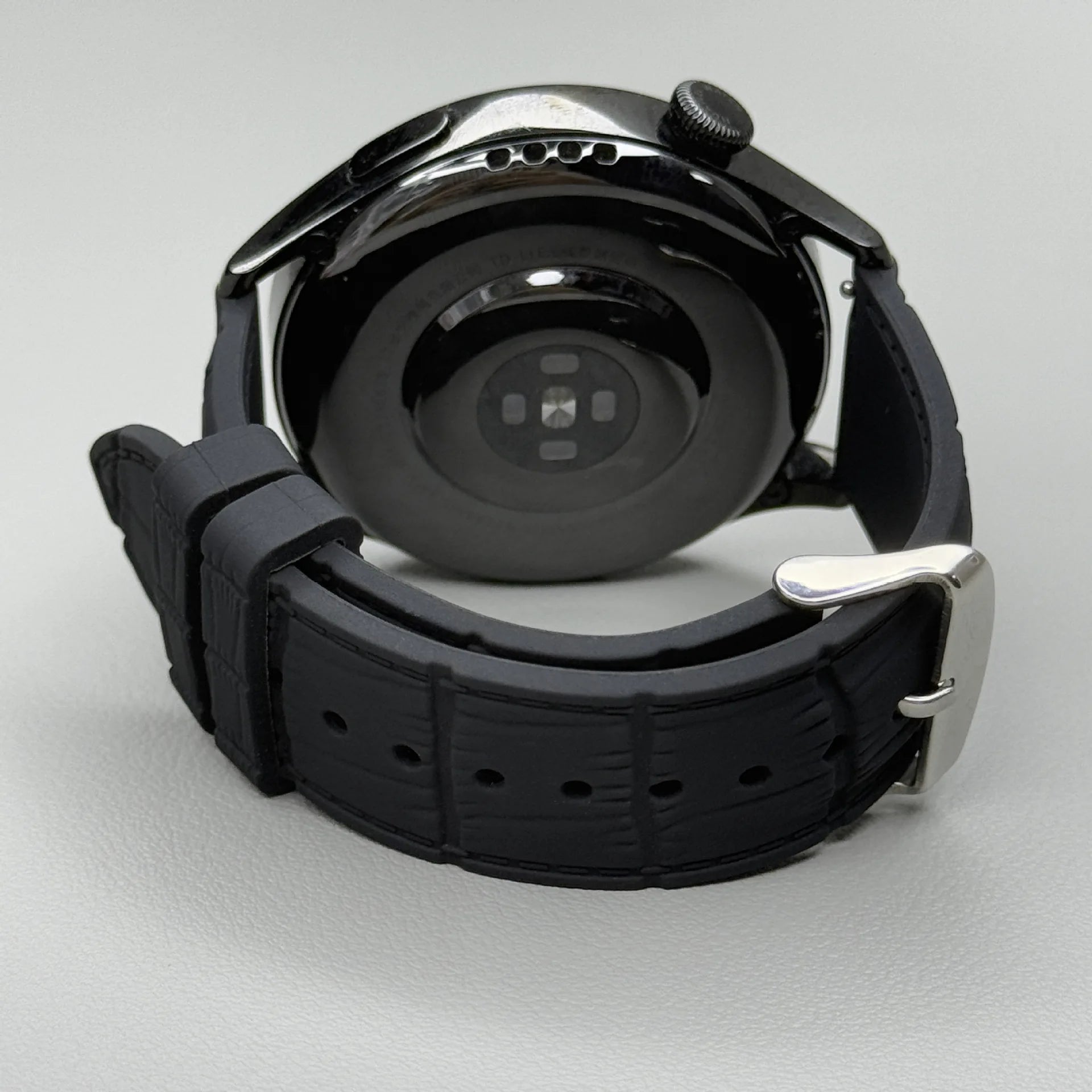 1GW Black leather-texture silicone watch strap with silver pin buckle, shown fitted to a watch