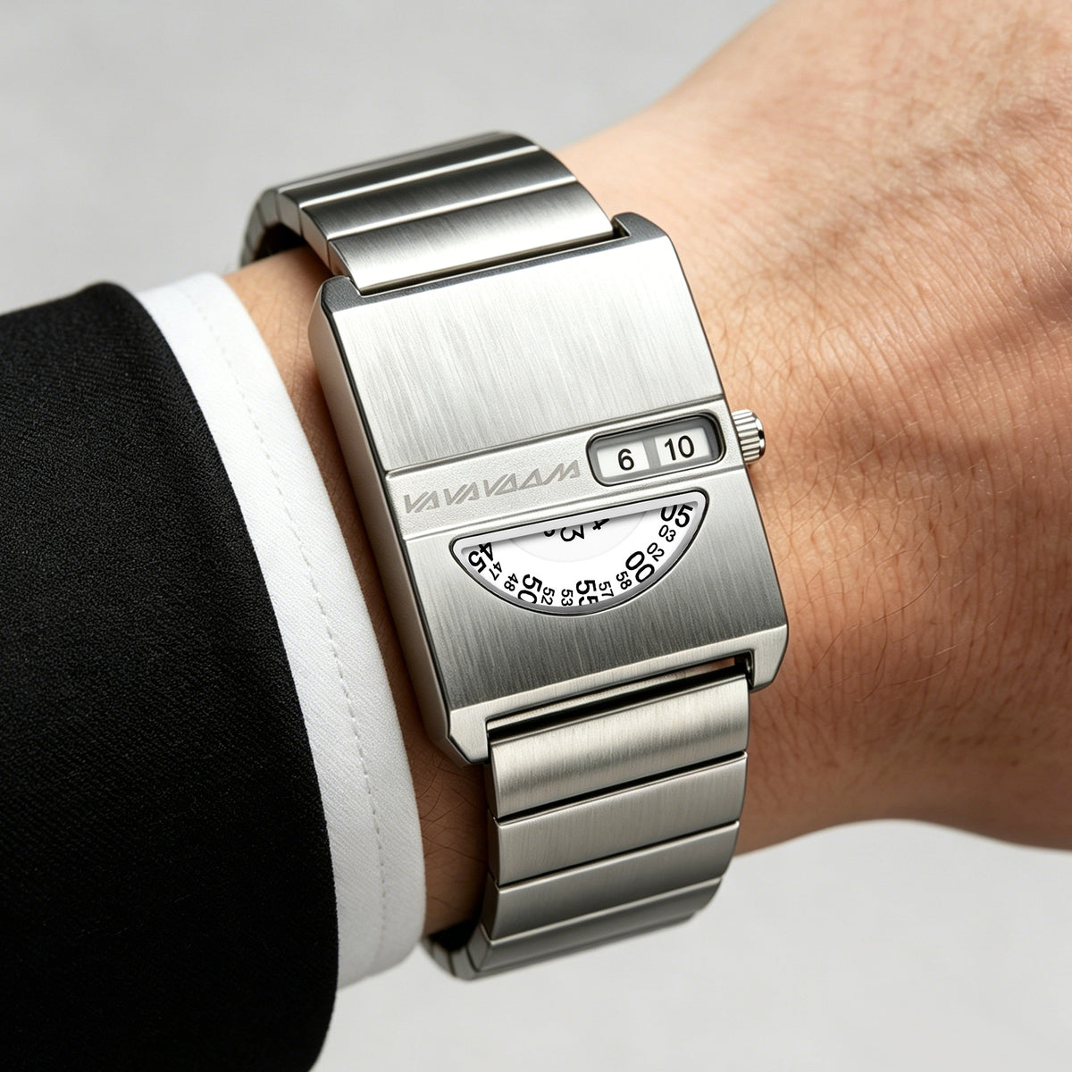 VA VA VOOM No-Hands Square watch in silver worn on the wrist with a shirt cuff