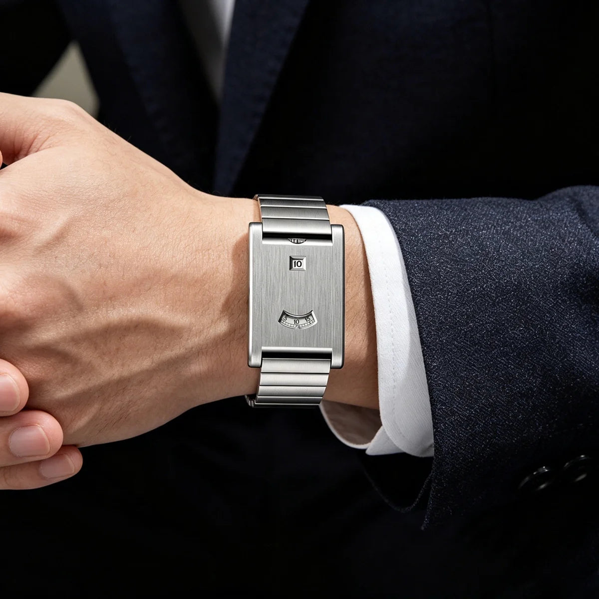 Rolling disc watch with steel bracelet worn with a white shirt cuff