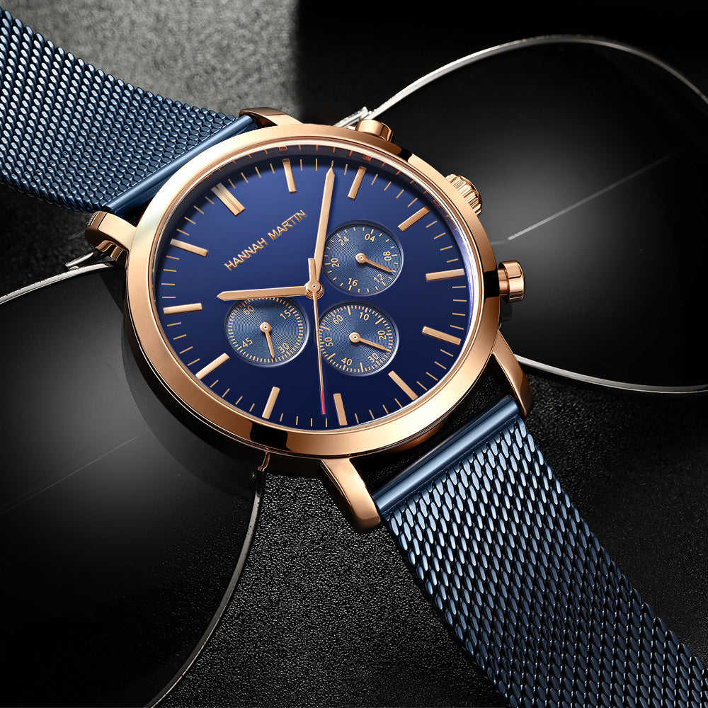 HANNAH MARTIN Three-Subdial Mesh 45mm, blue dial and rose gold case on blue steel mesh, angled studio view