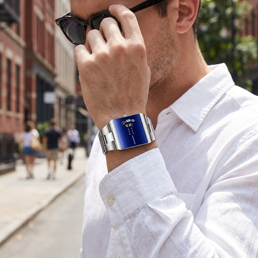 VA VA VOOM 2693 Rectangle watch, silver case with blue dial, worn on the wrist outdoors on a city street