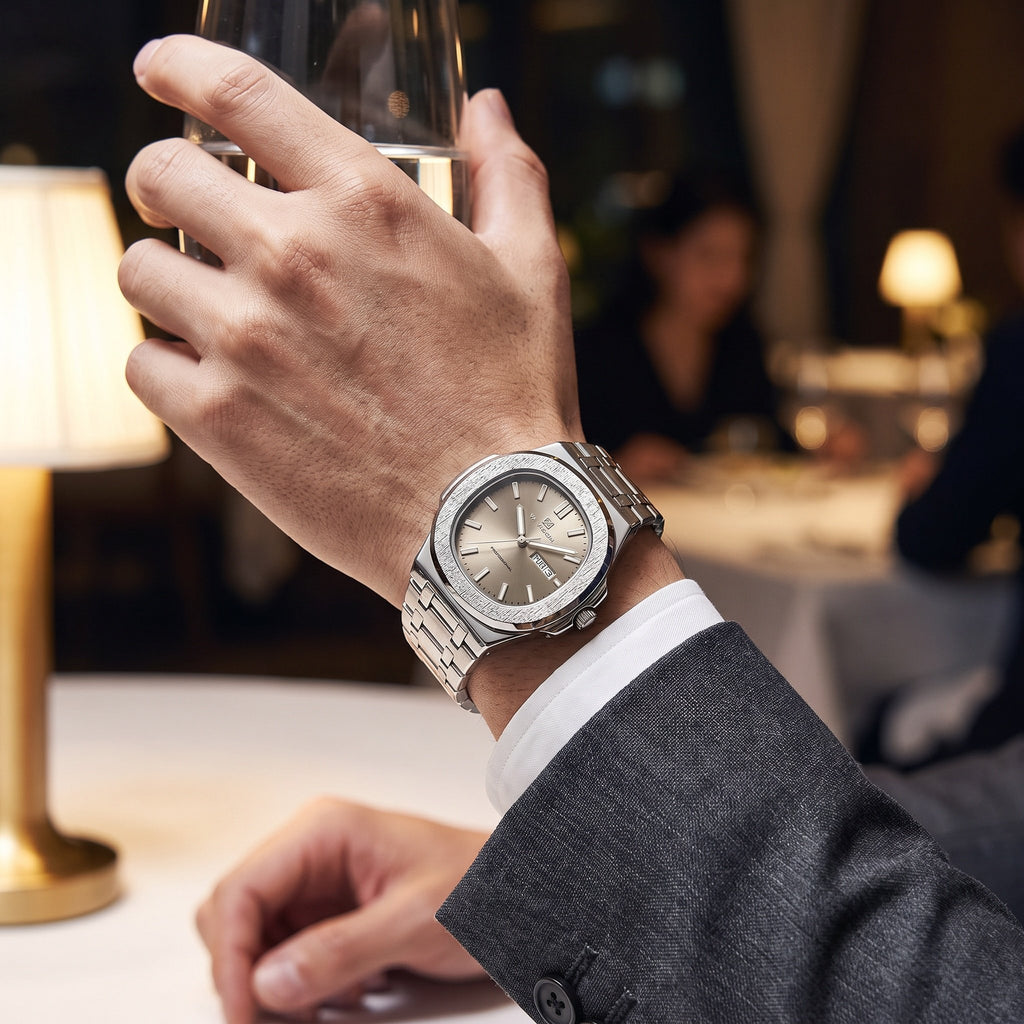 VA VA VOOM Octagonal Day-Date watch, steel with textured bezel and sand dial, worn with a suit at a restaurant table