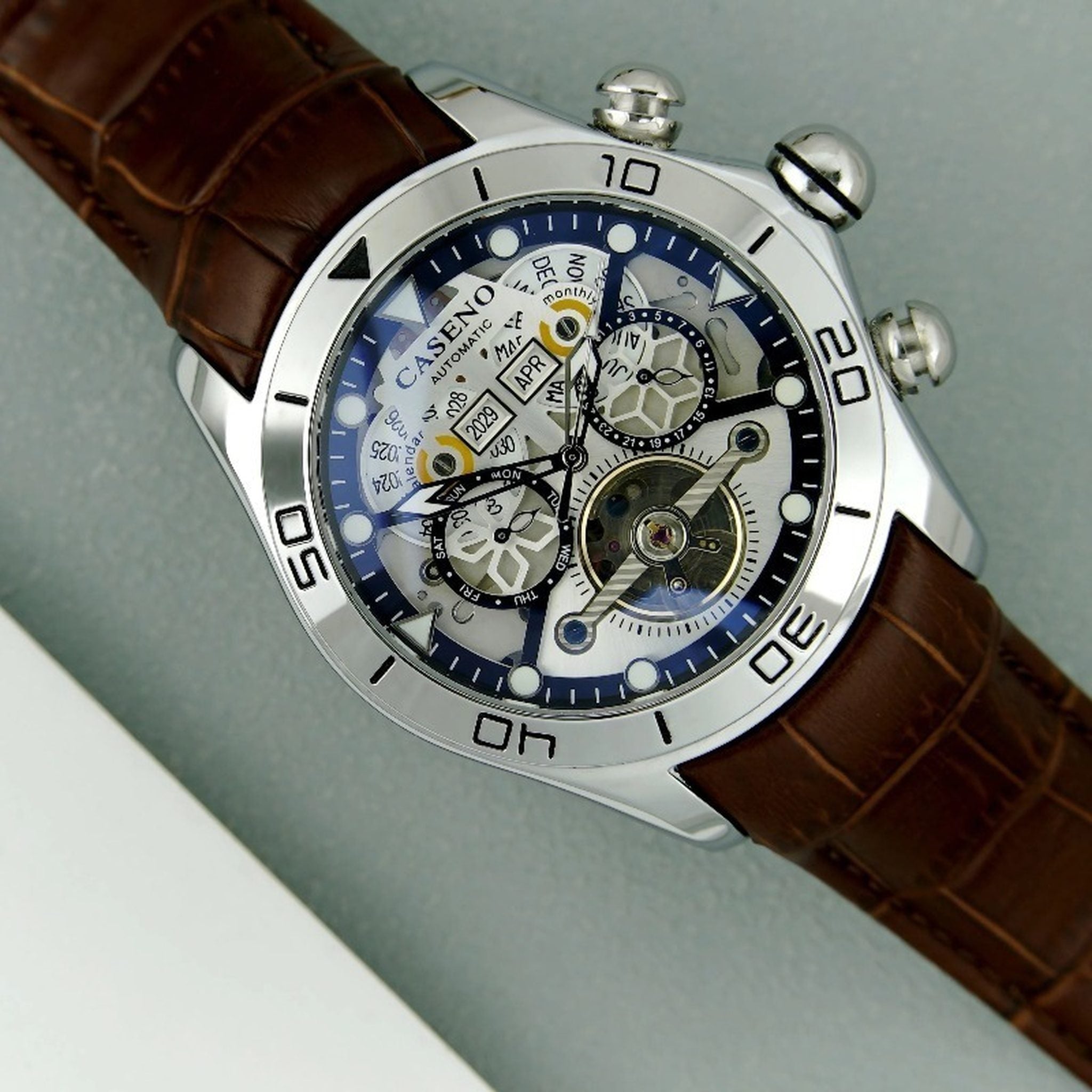 AWC skeleton automatic watch with silver case, white dial, and brown leather strap