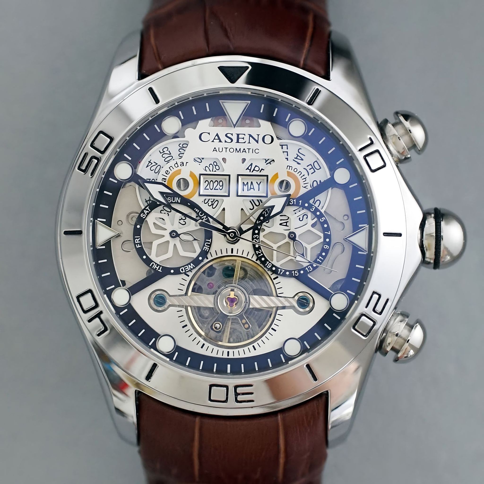 AWC skeleton automatic watch front view with white dial and brown leather strap