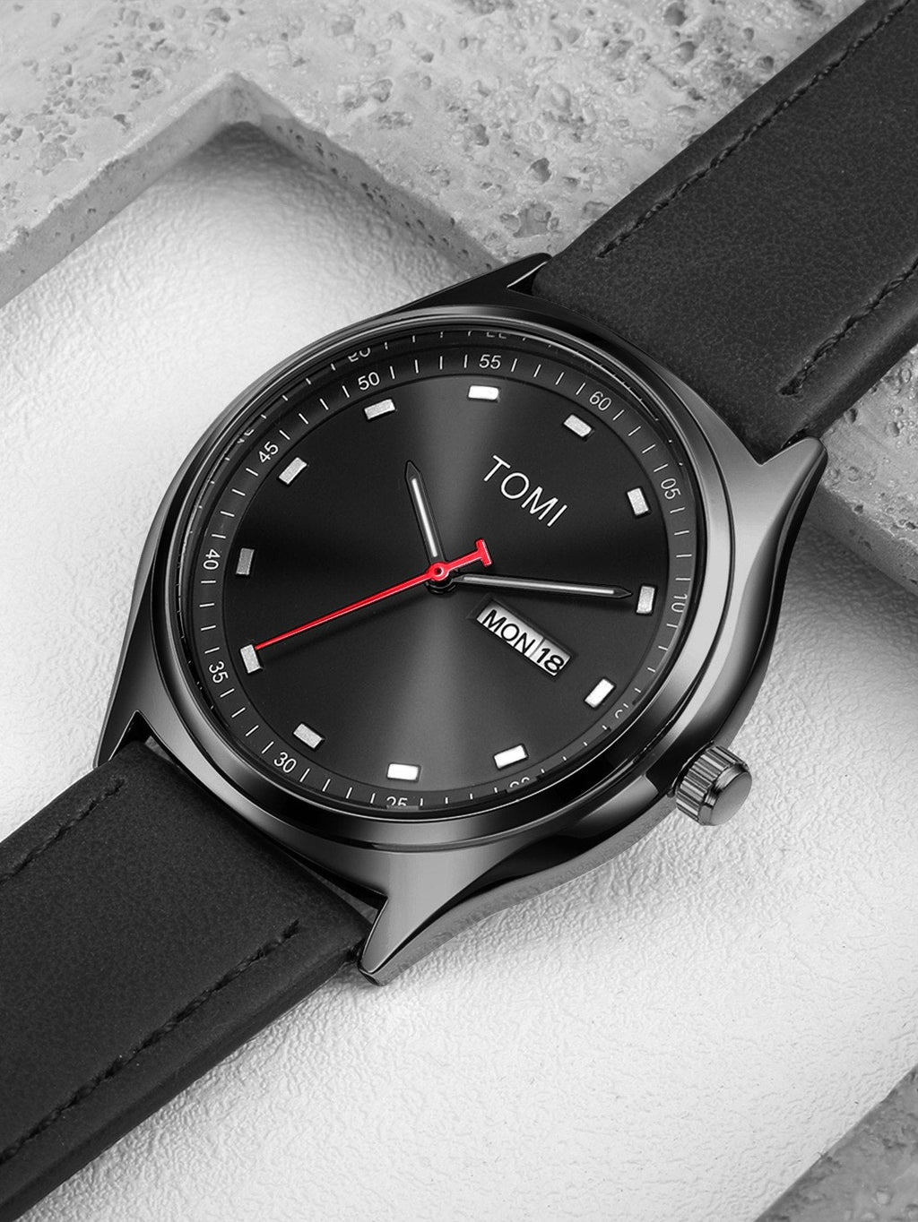 TOMI Black minimalist calendar watch supplier flat lay