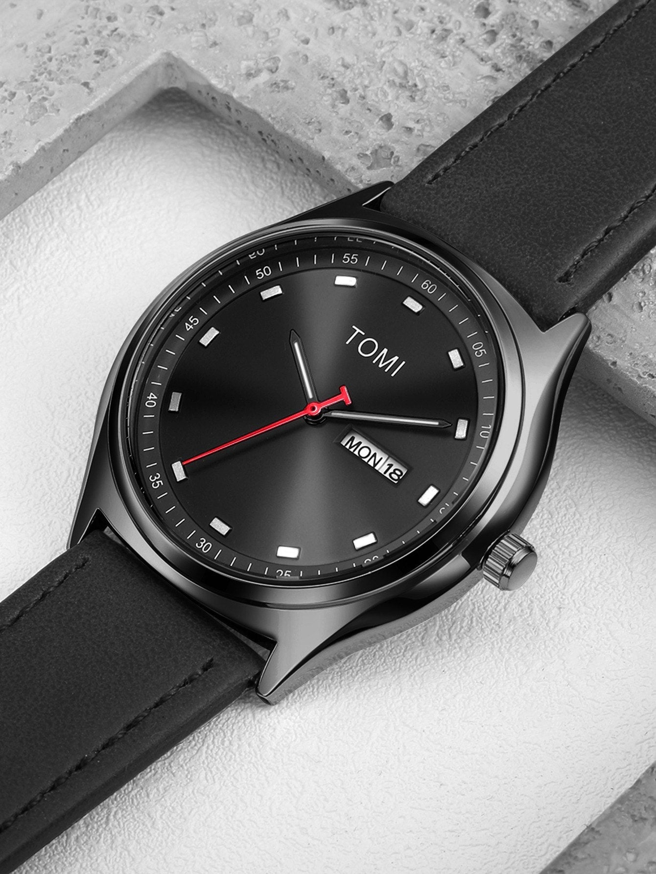 TOMI Black minimalist calendar watch supplier flat lay