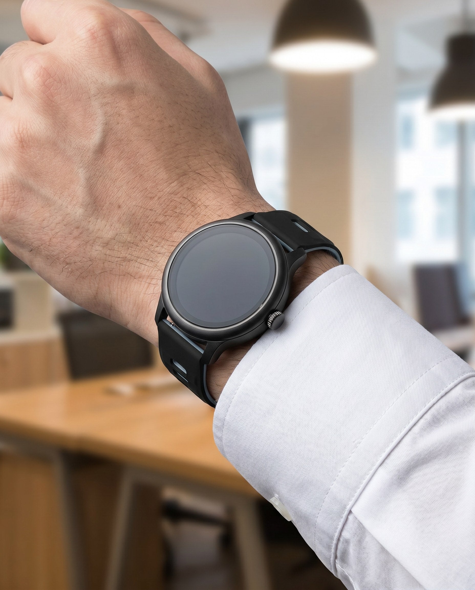Black and gray two-tone silicone quick-release watch strap on a watch in a business setting