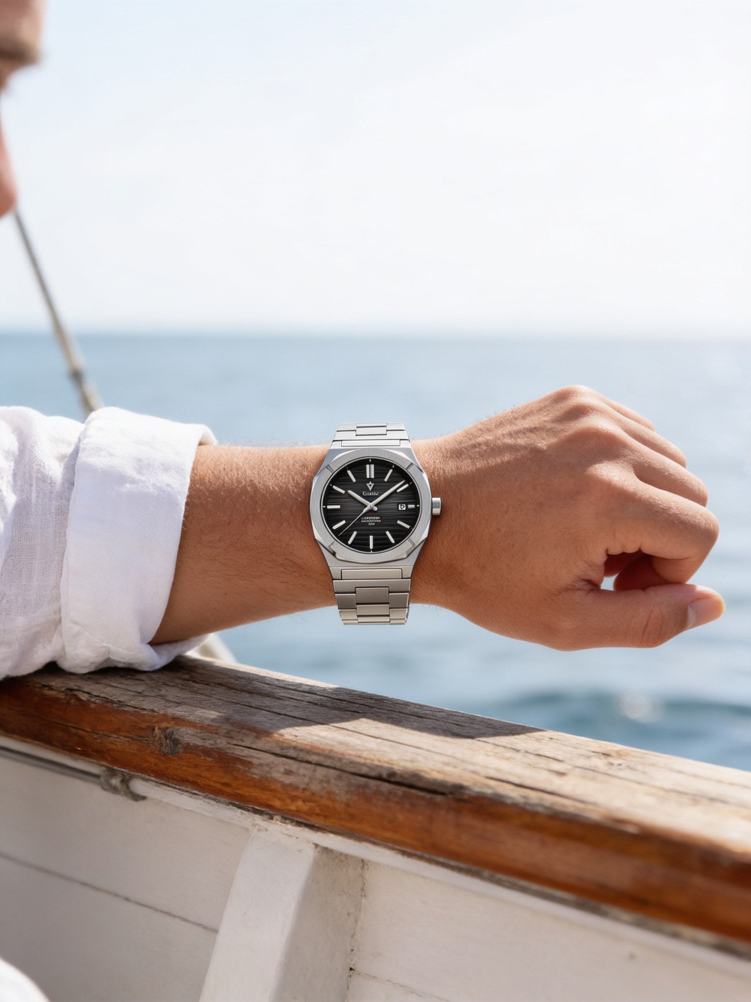 CADISEN sapphire integrated-bracelet automatic 40mm black dial worn on a man's wrist