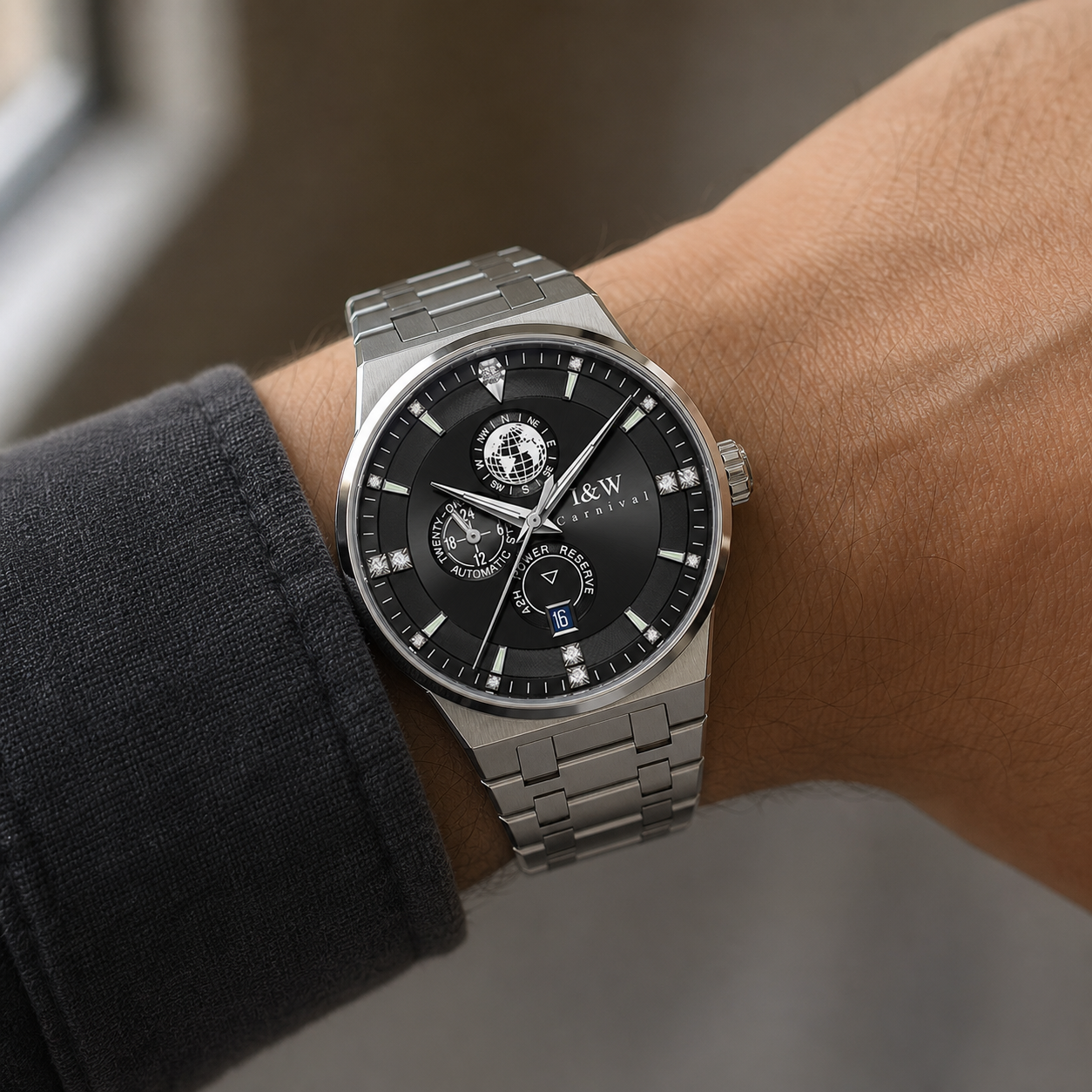 Carnival black-dial automatic watch with globe display and steel bracelet worn on wrist