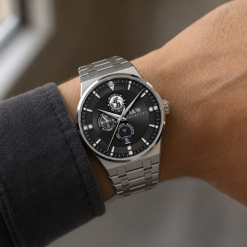 Carnival black-dial automatic watch with globe display and steel bracelet worn on wrist