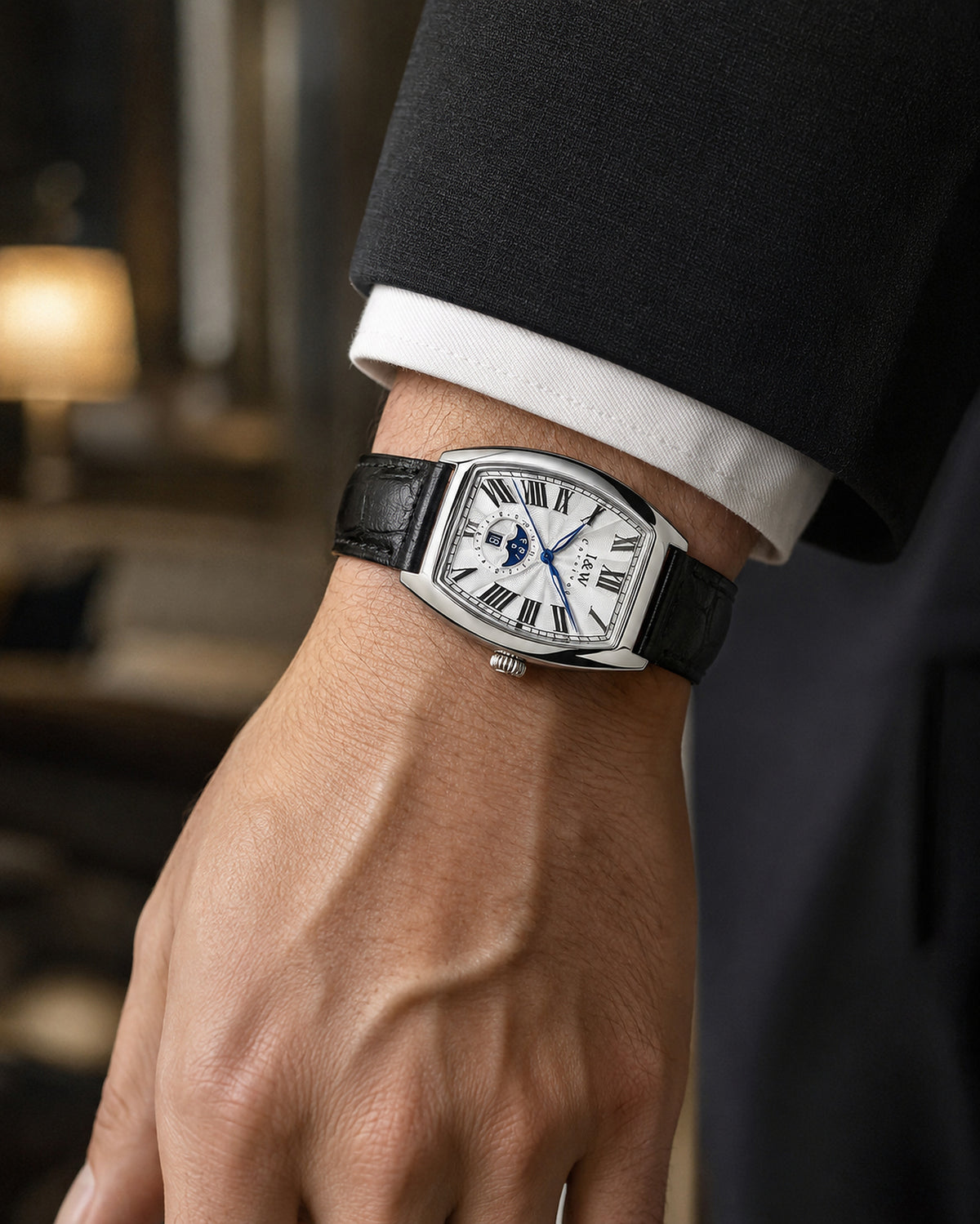 Man wearing Carnival IW55810G white dial automatic watch with black leather strap in a business setting