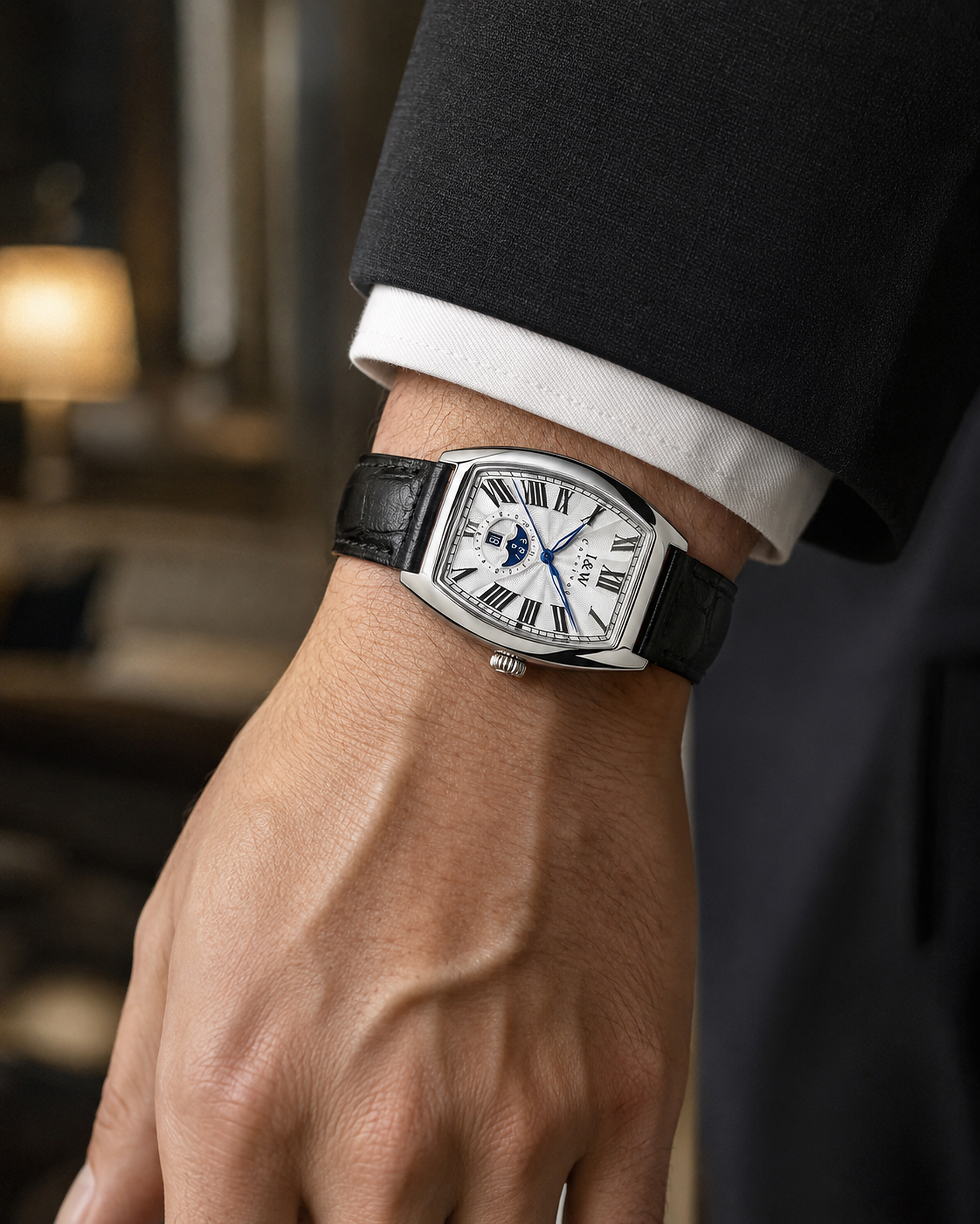 Man wearing Carnival IW55810G white dial automatic watch with black leather strap in a business setting