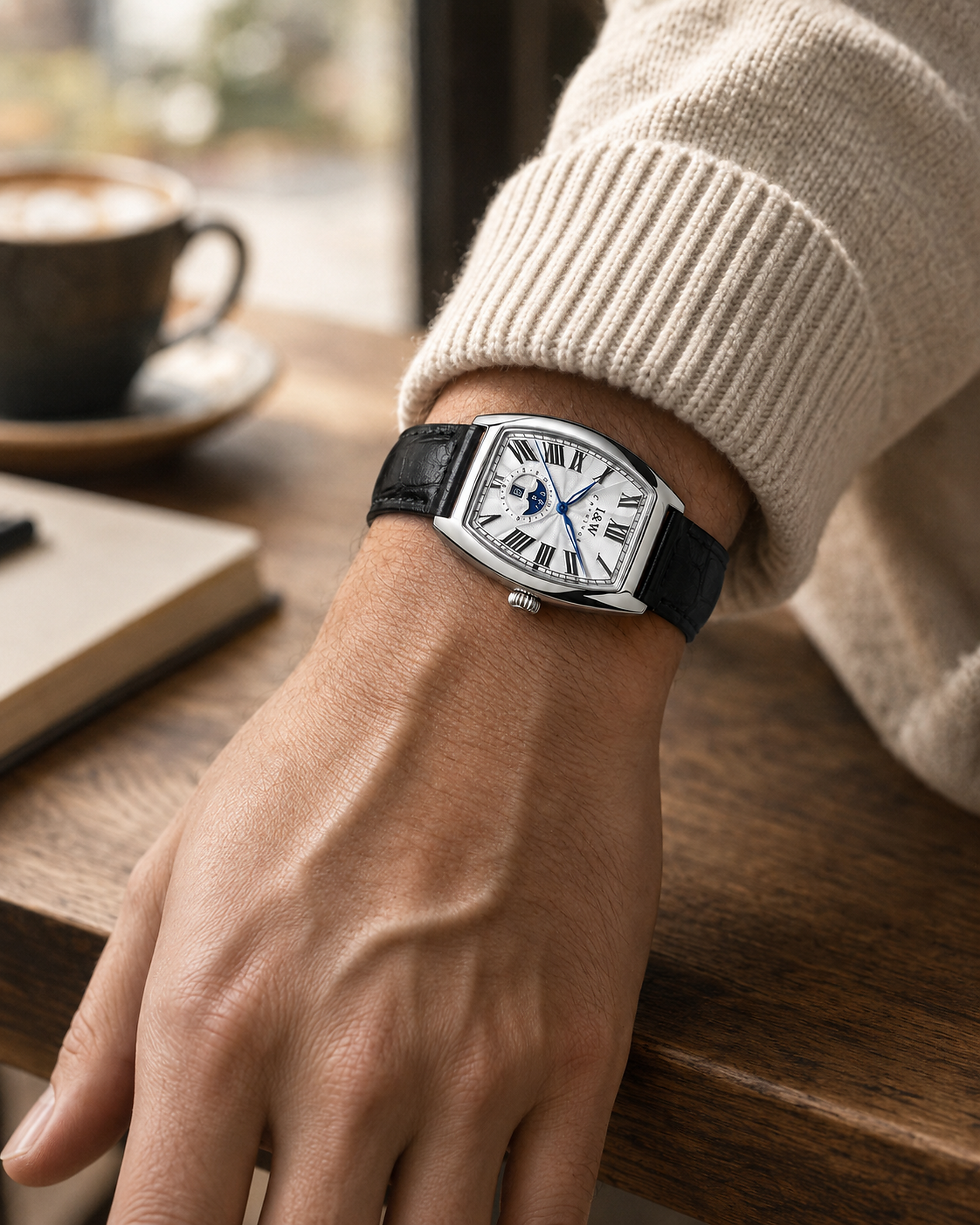 Man wearing Carnival IW55810G white dial automatic watch with black leather strap at a café