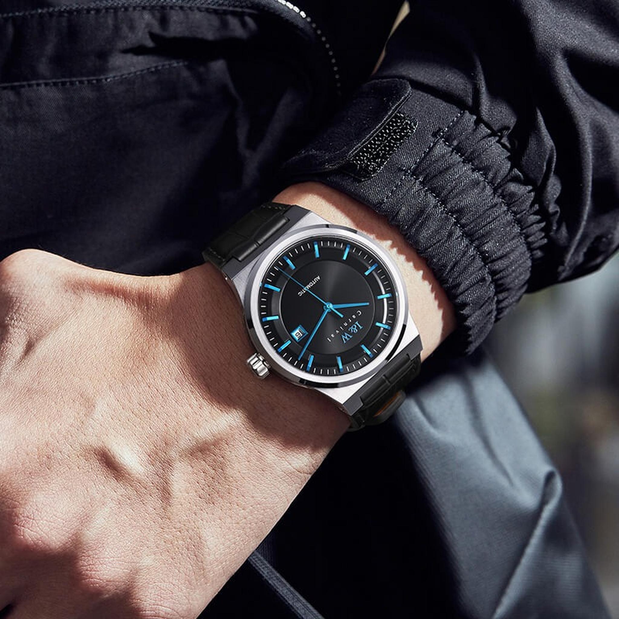 Carnival IW612G black dial blue hands watch worn with dark jacket
