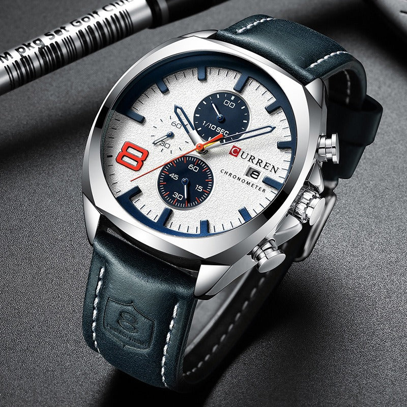 CURREN 47mm leather chronograph watch angled on a dark desk surface