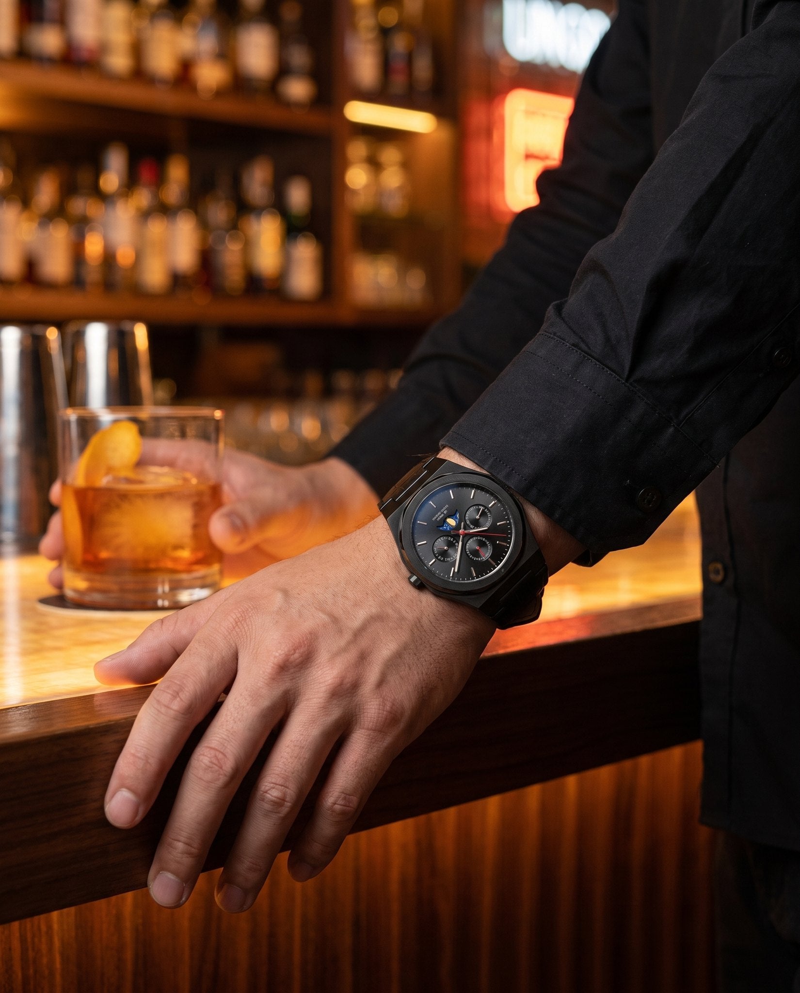 MARS Earth Edition watch on wrist at evening bar, nightlife scene