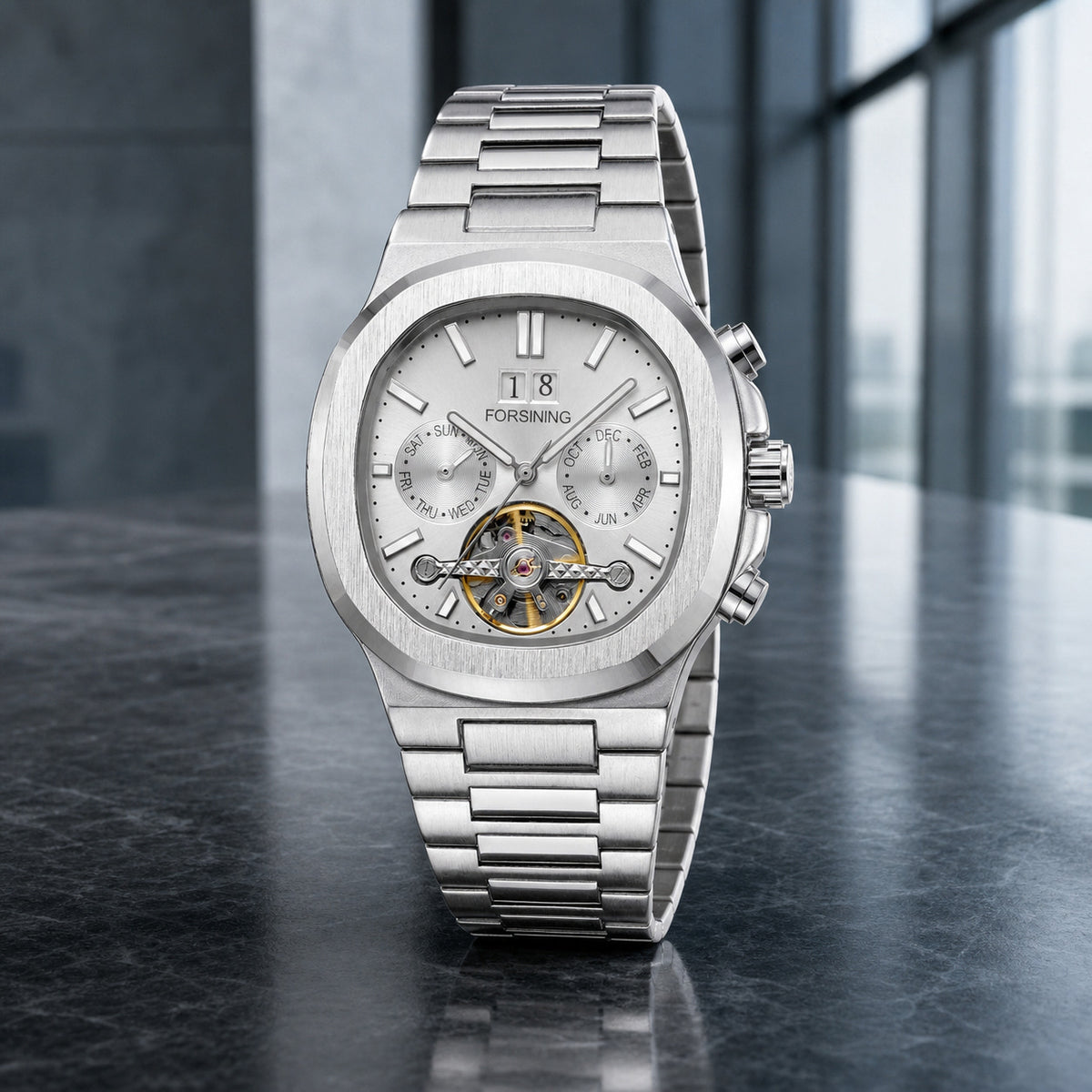 FORSINING 481 silver open-heart automatic watch in a modern boardroom