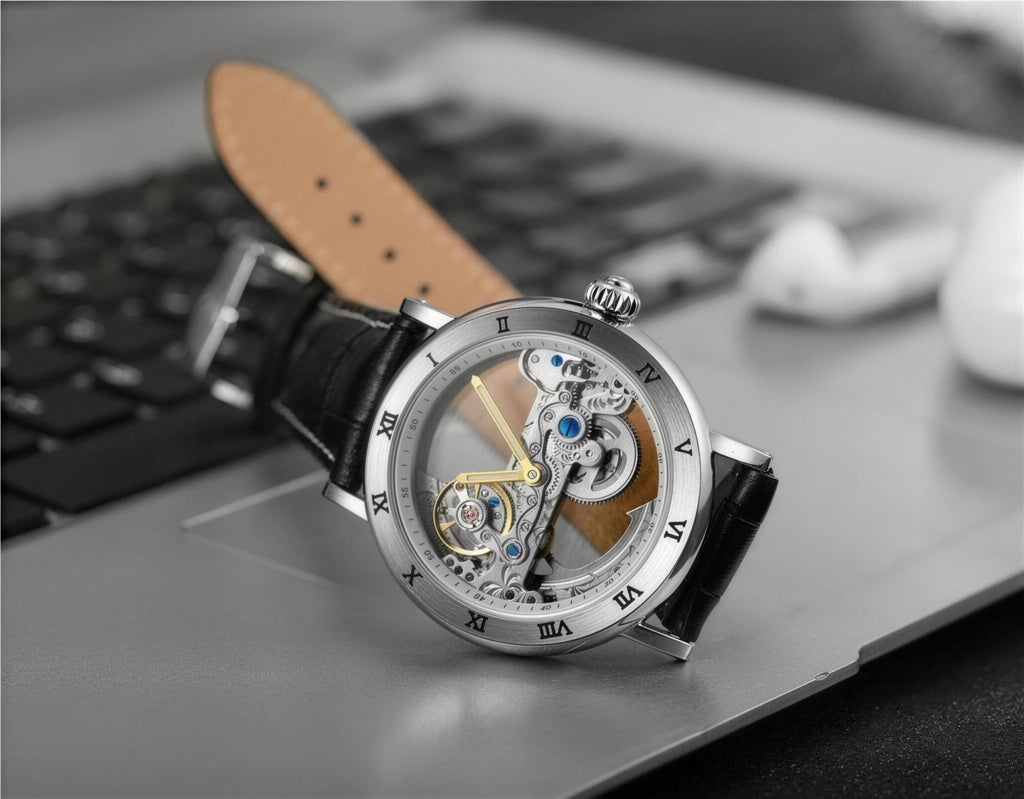 FORSINING GMT1003 skeleton automatic watch resting on a laptop keyboard