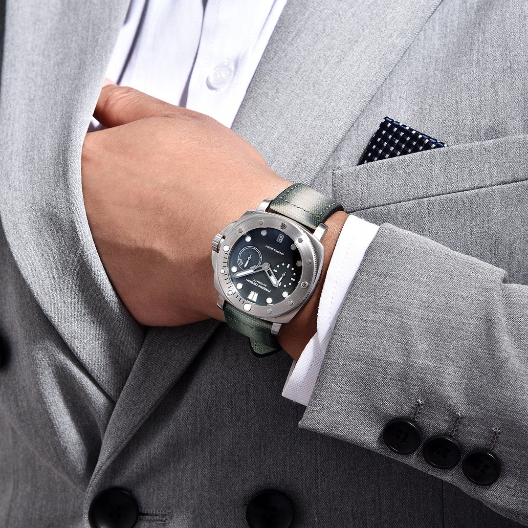 Pagani Design gray-dial automatic watch worn on the wrist with a suit cuff