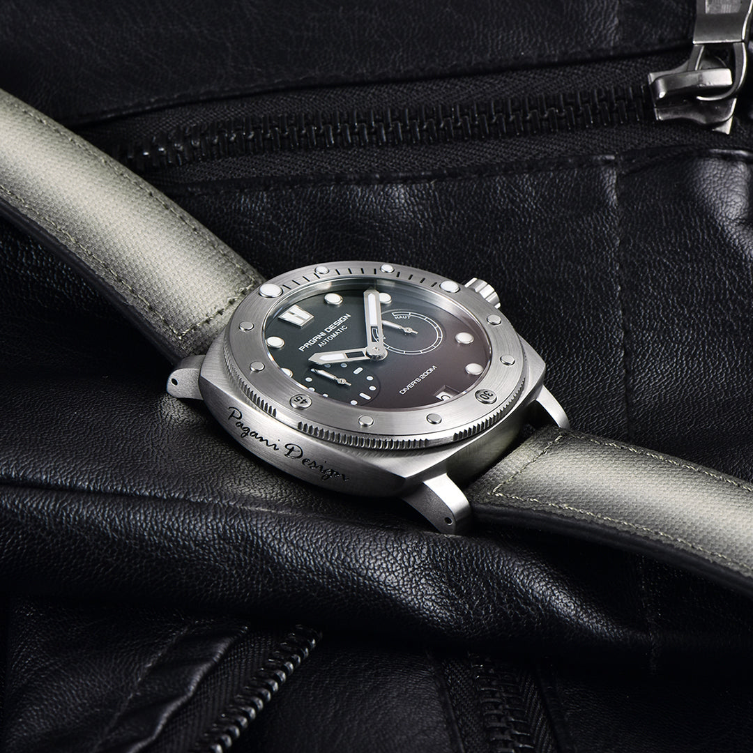 Pagani Design gray-dial automatic watch resting on a black leather jacket