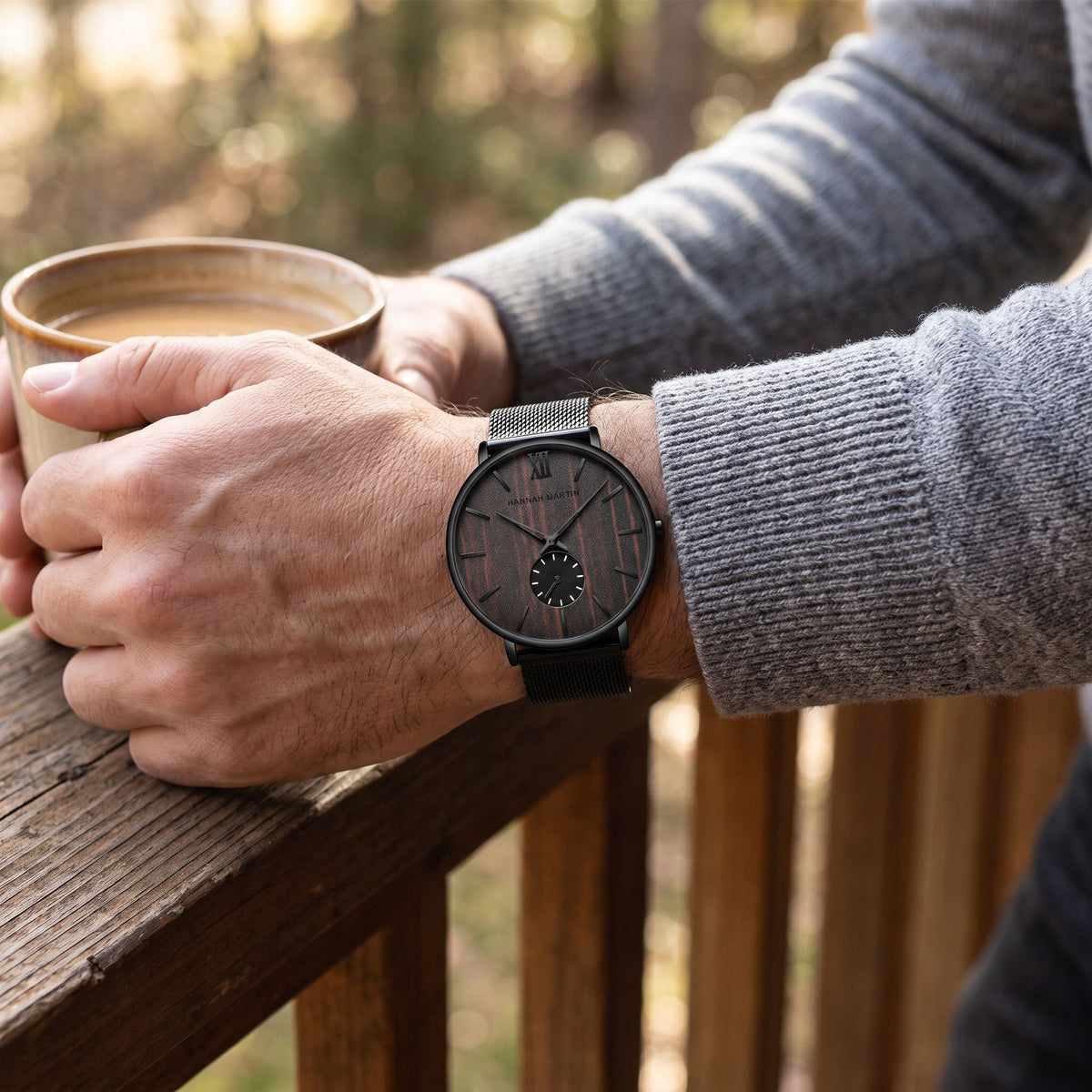 HANNAH MARTIN 3D Wood Stripe 40mm with dark wood dial worn on the wrist holding a coffee mug outdoors