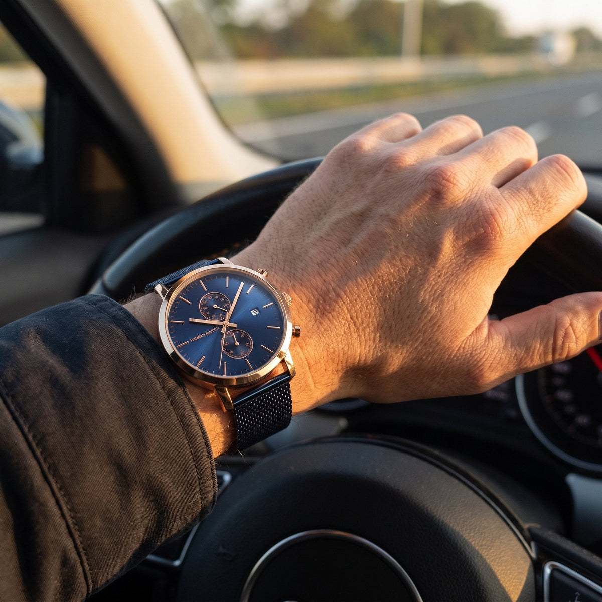 HANNAH MARTIN Mesh Chronograph 45mm, two-subdial blue dial and rose gold case, worn on the wrist while driving