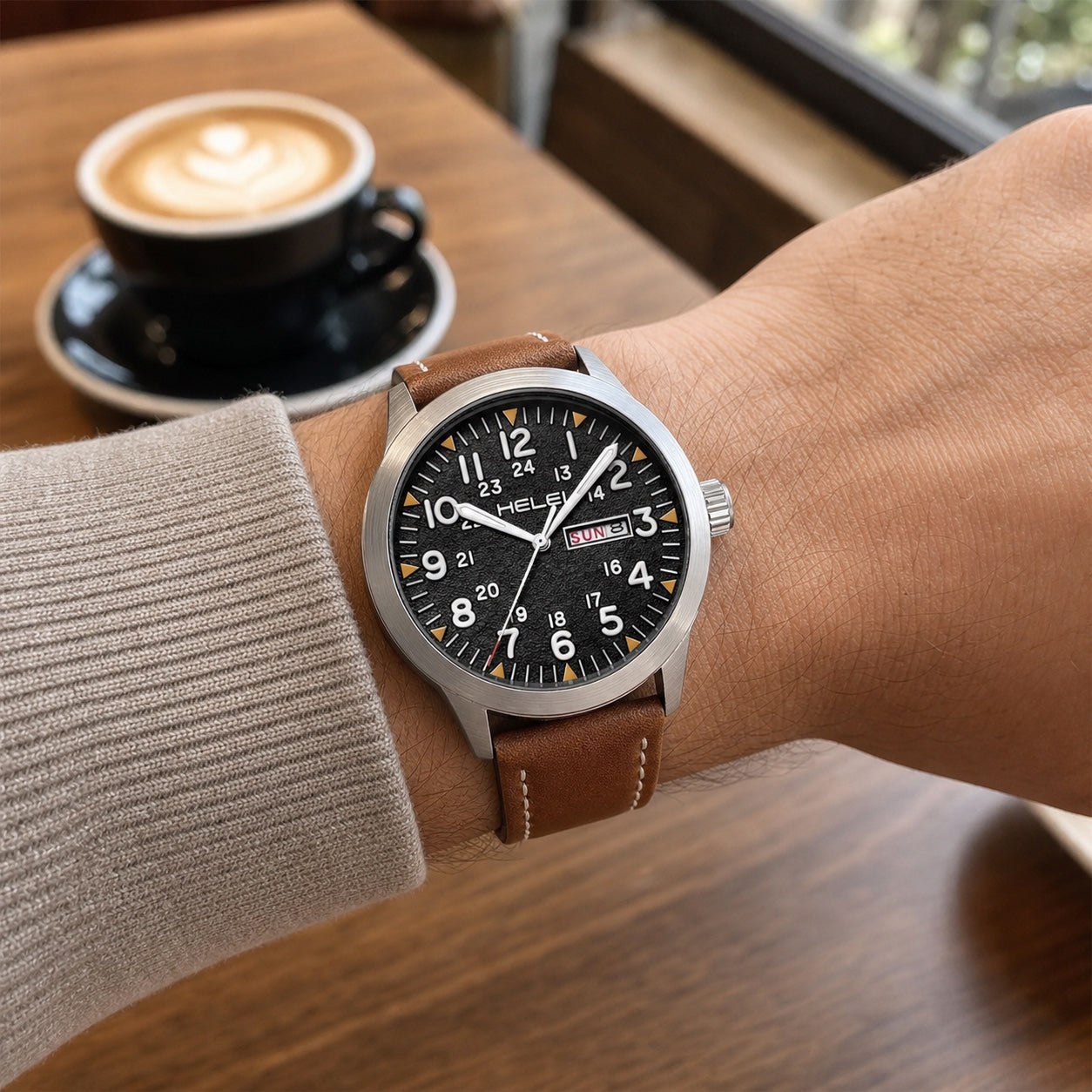 HELEI 42mm Silver case black dial watch with coffee leather strap worn at a cafe