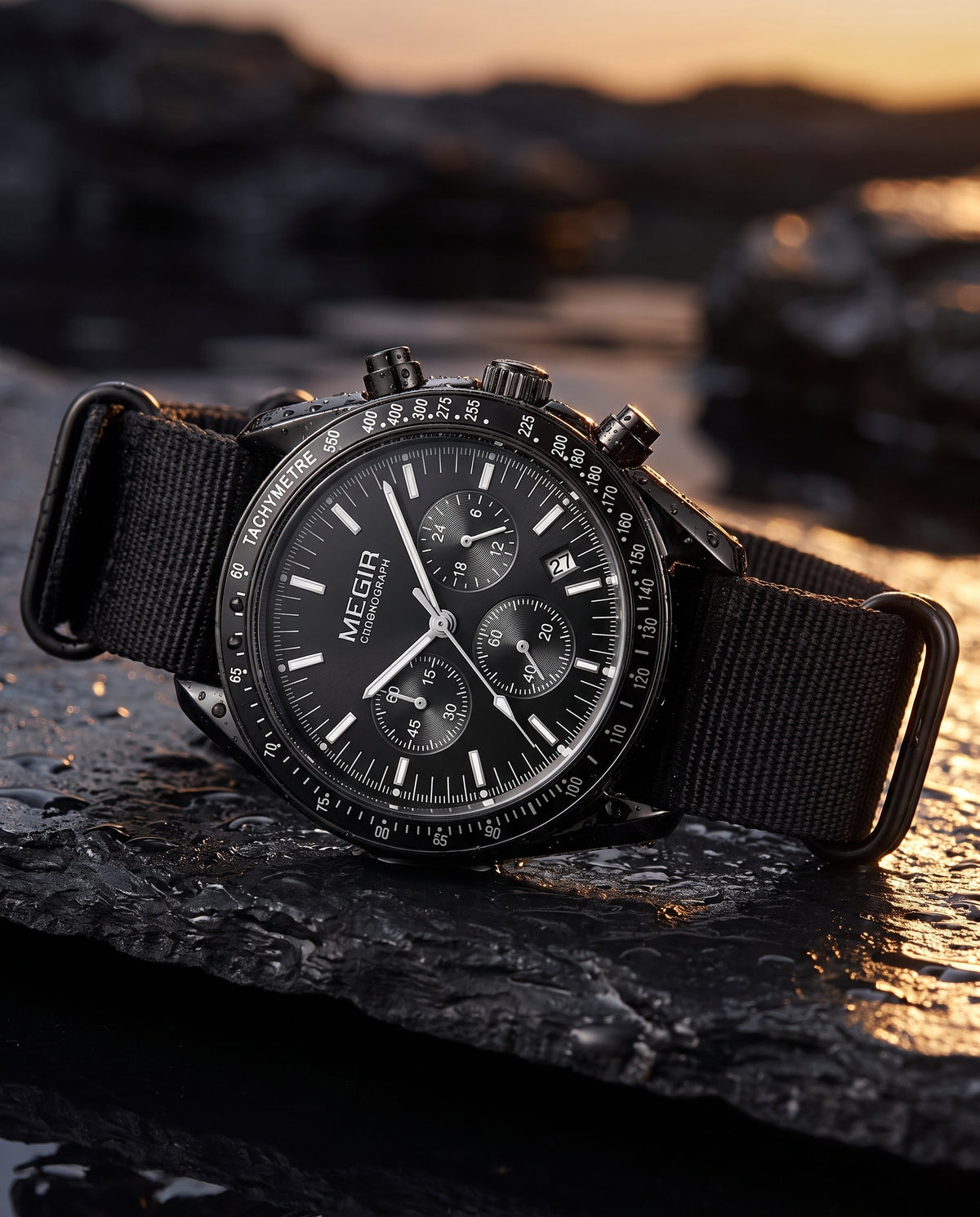 MEGIR black chronograph lifestyle shot on dark slate with water droplets
