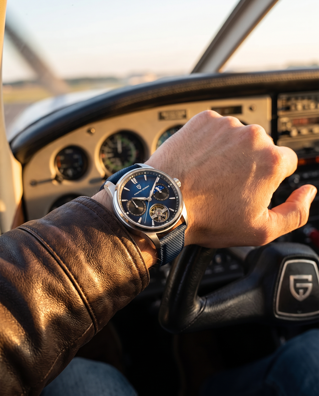 Pagani PD-YS021 worn on the left wrist in an aircraft cockpit at golden hour